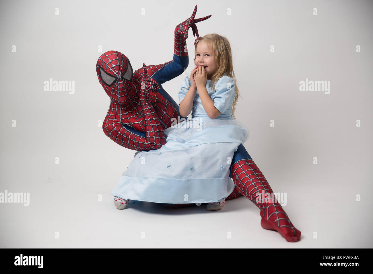 Israel, Tel Aviv October 14, 2018. The spiderman is holding a little girl in his arms. A man in a spiderman suit came to congratulate the child on his birthday. Spiderman Costume Rental. Stock Photo