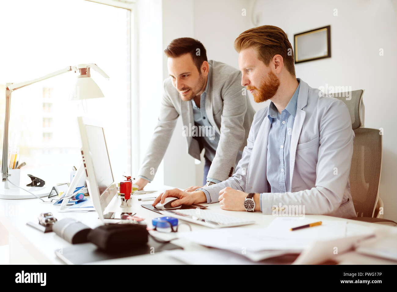 Coworkers working on project together Stock Photo