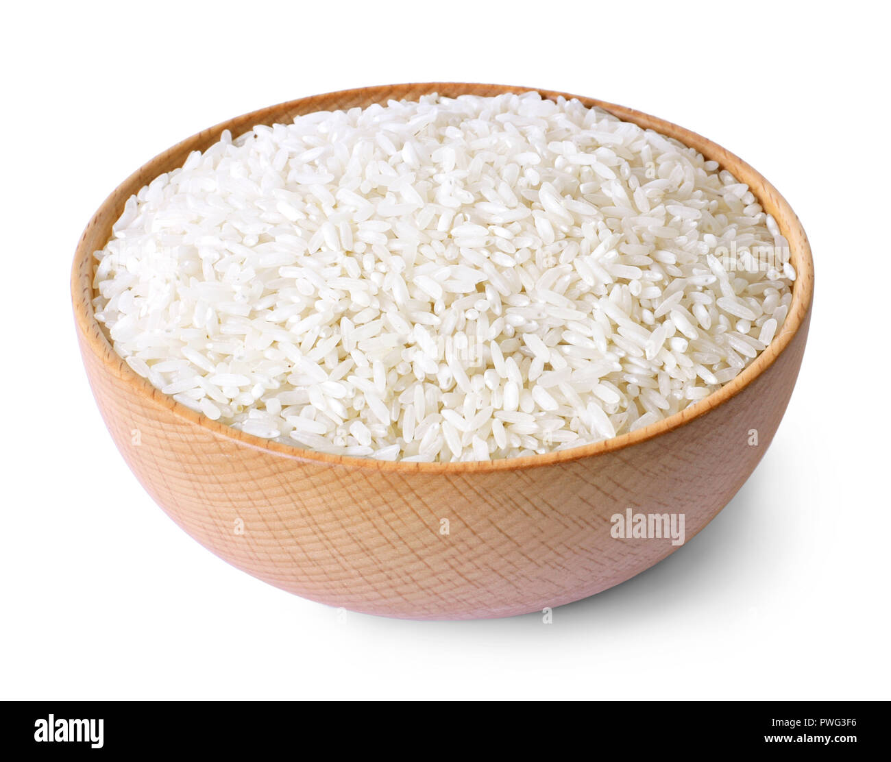 Raw, parboiled rice in a wooden bowl. Rice dish, isolated on white background, diet or healthy eating scene. Stock Photo