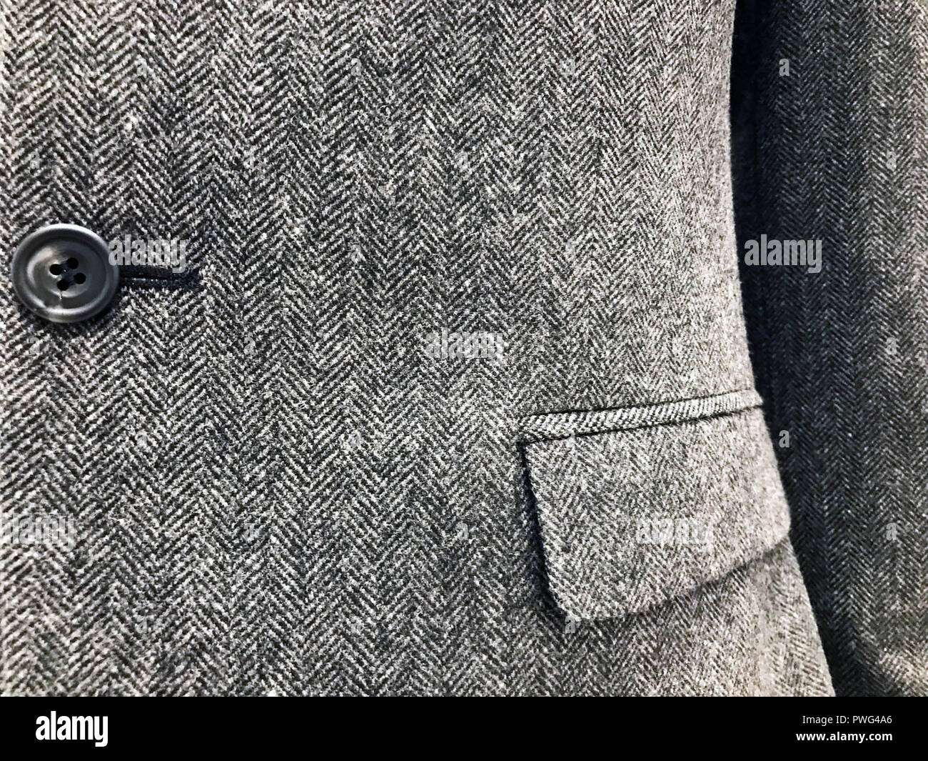 Mans textured suit material close up in grey. Stock Photo