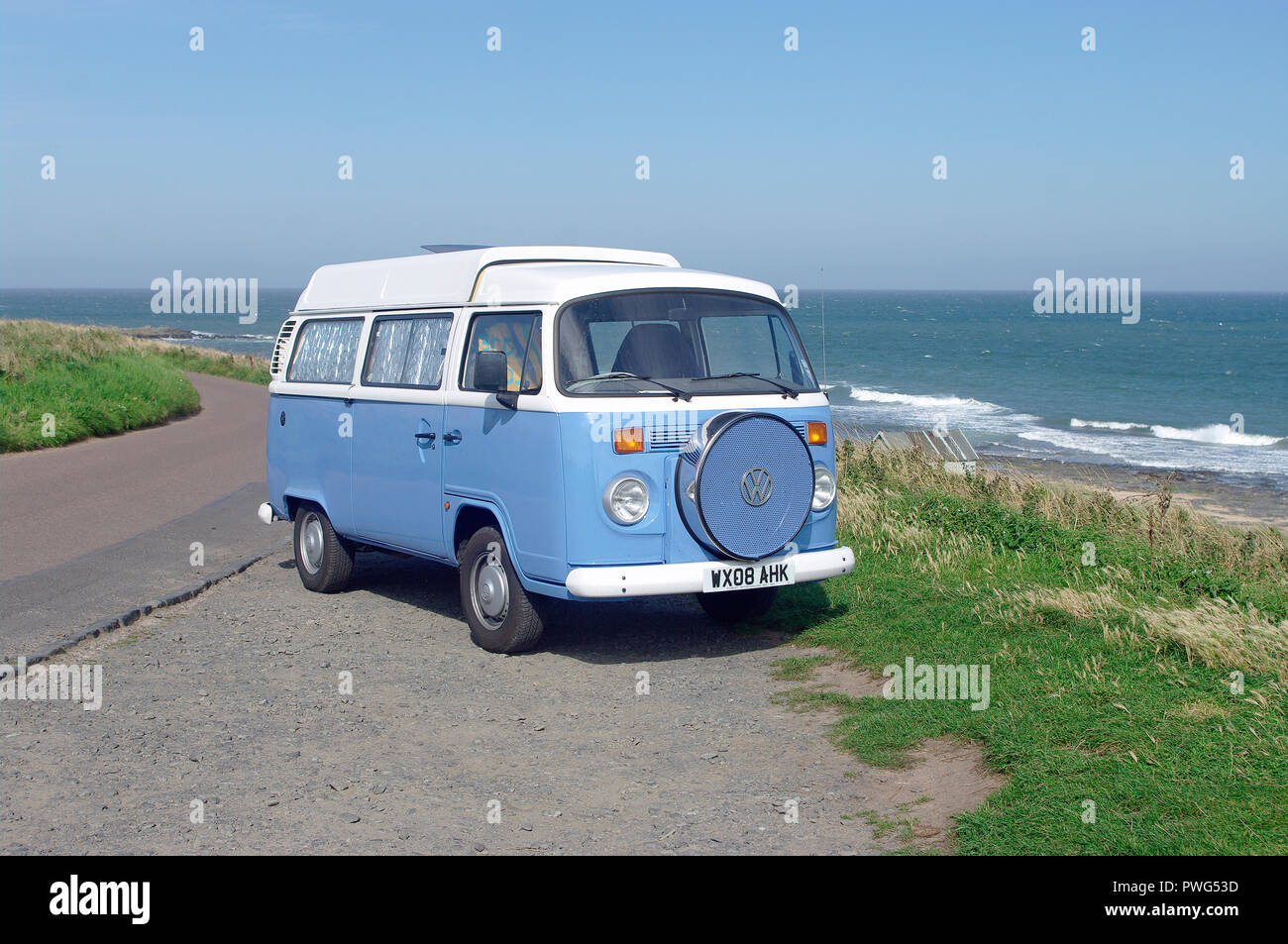 VW Camper Van at coast Stock Photo