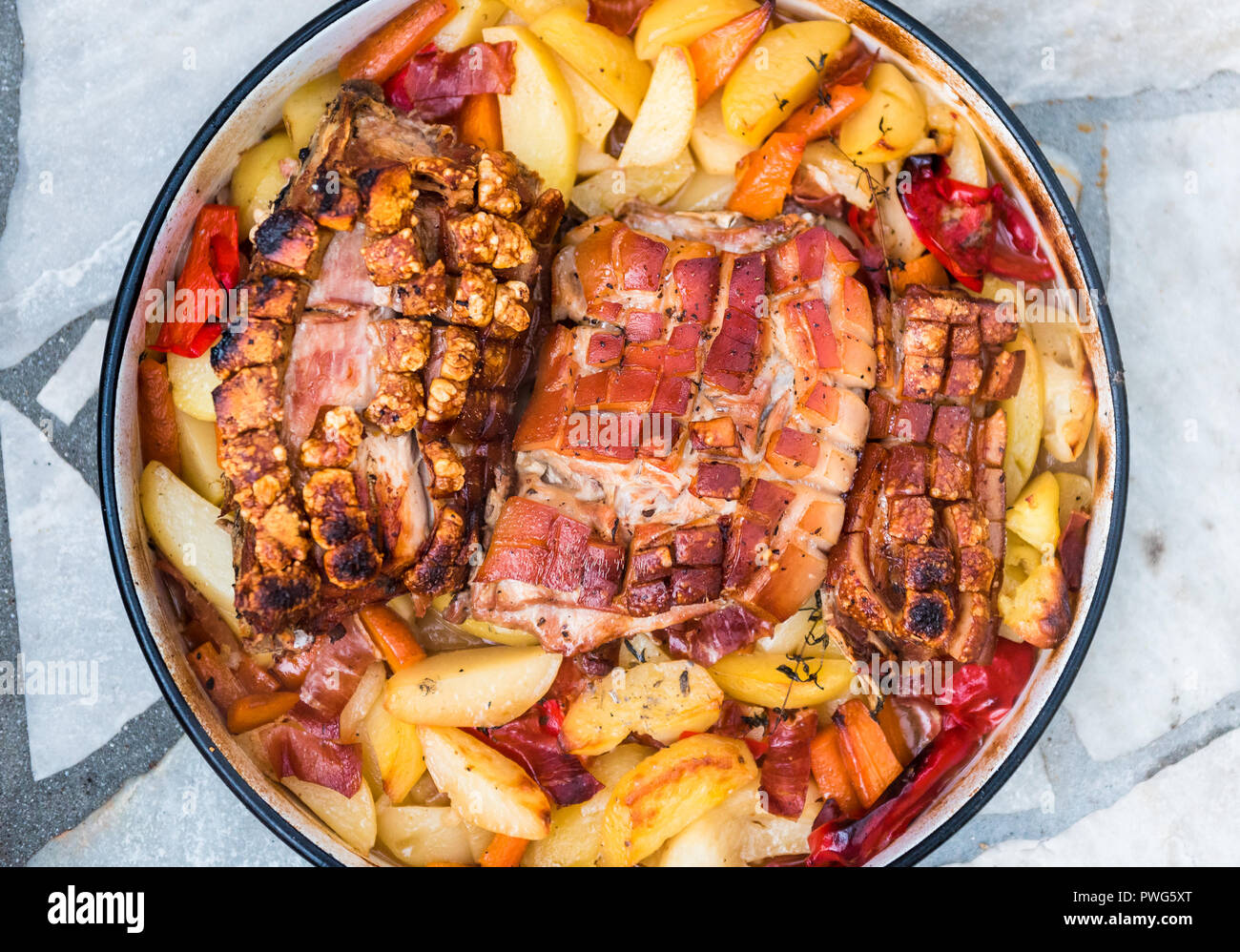 Preparing and cooking pork roast in traditional metal pot Peka. Meat