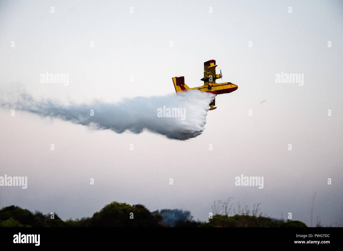 firefighting aircraft, canadair in action, throwing water into the fire