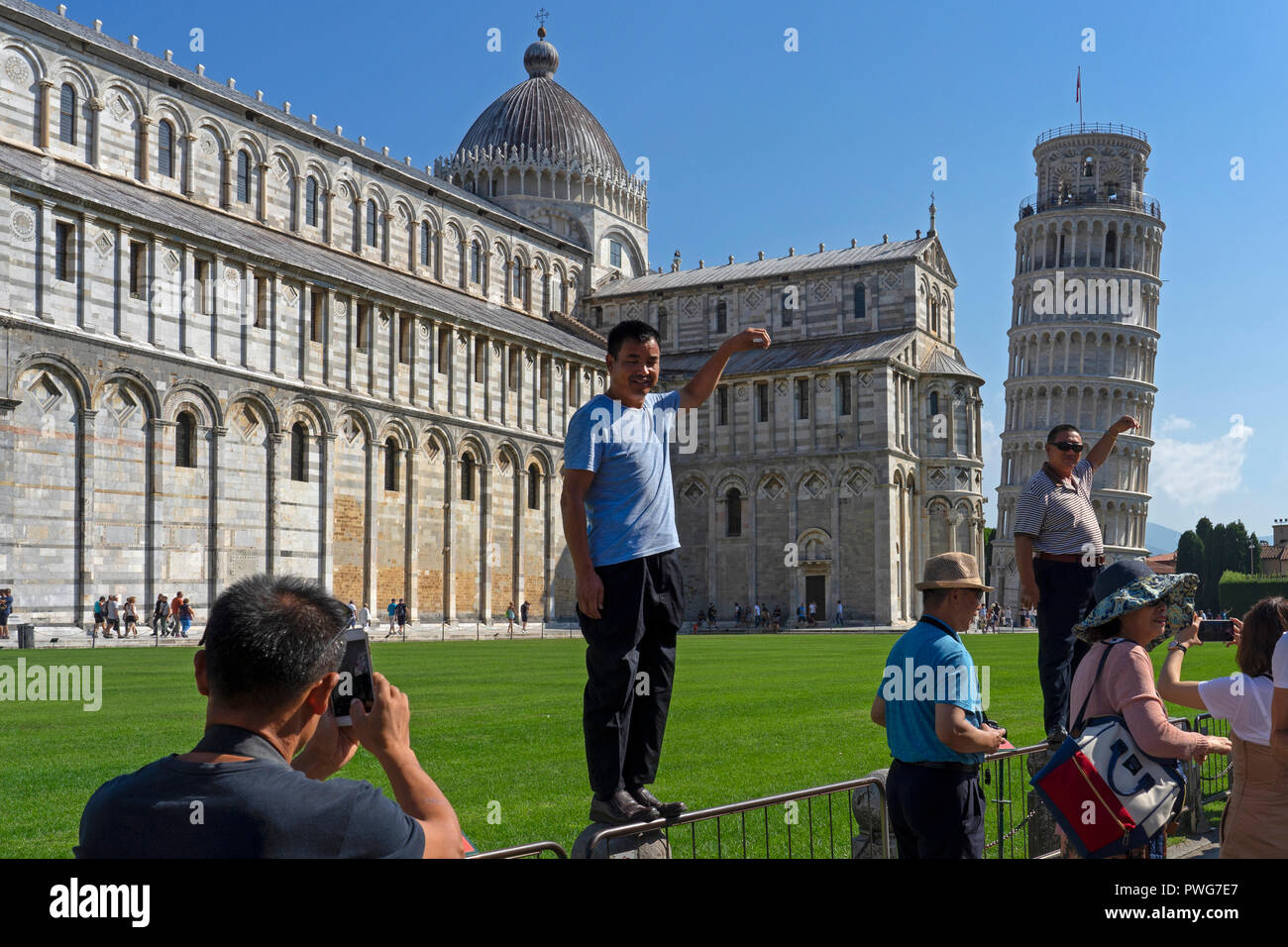 Tourists posing by the leaning tower of pisa,Pisa,Tuscany,Italy,Europe Stock Photo