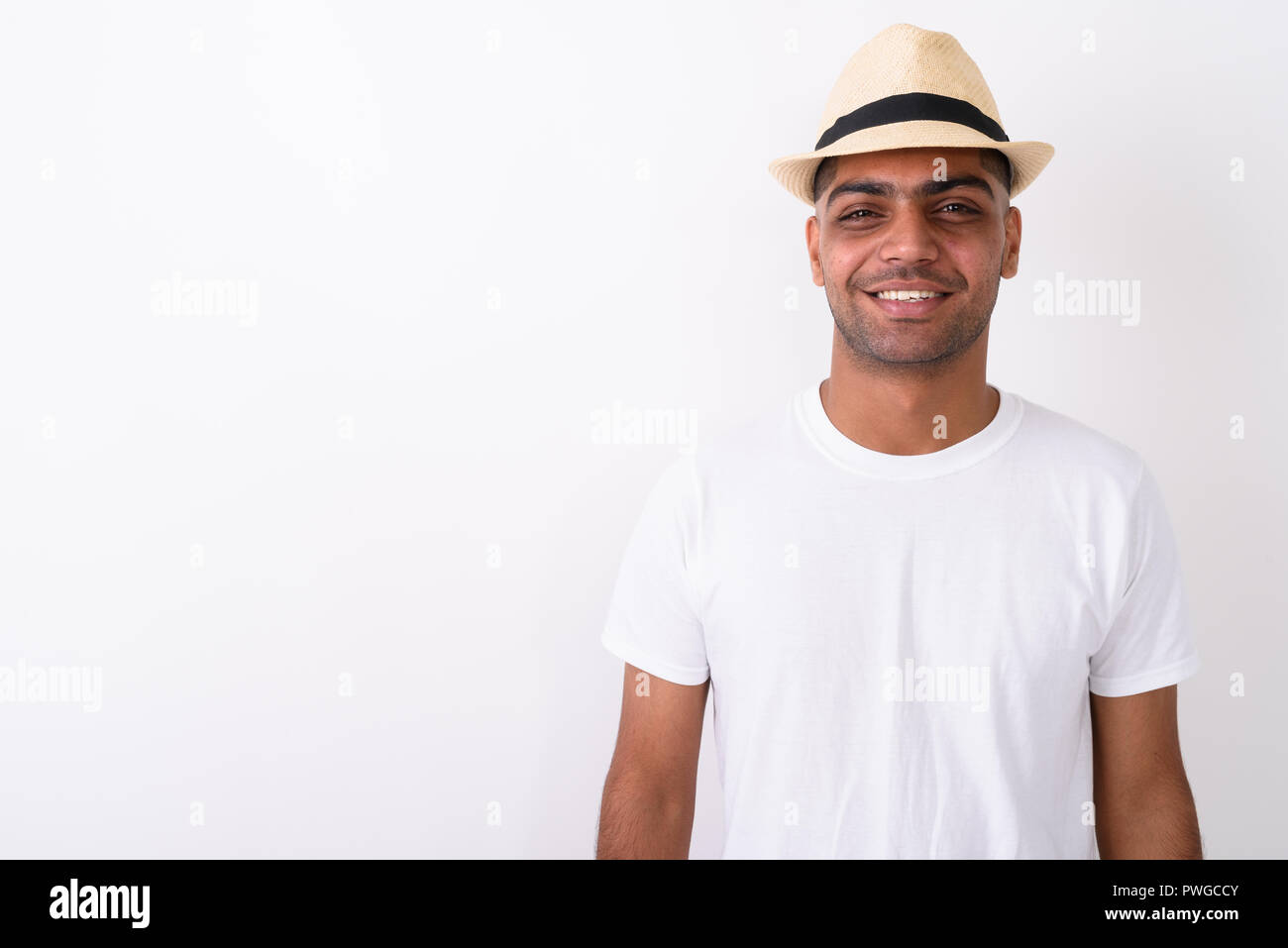 Young Indian tourist man wearing hat against white background Stock Photo