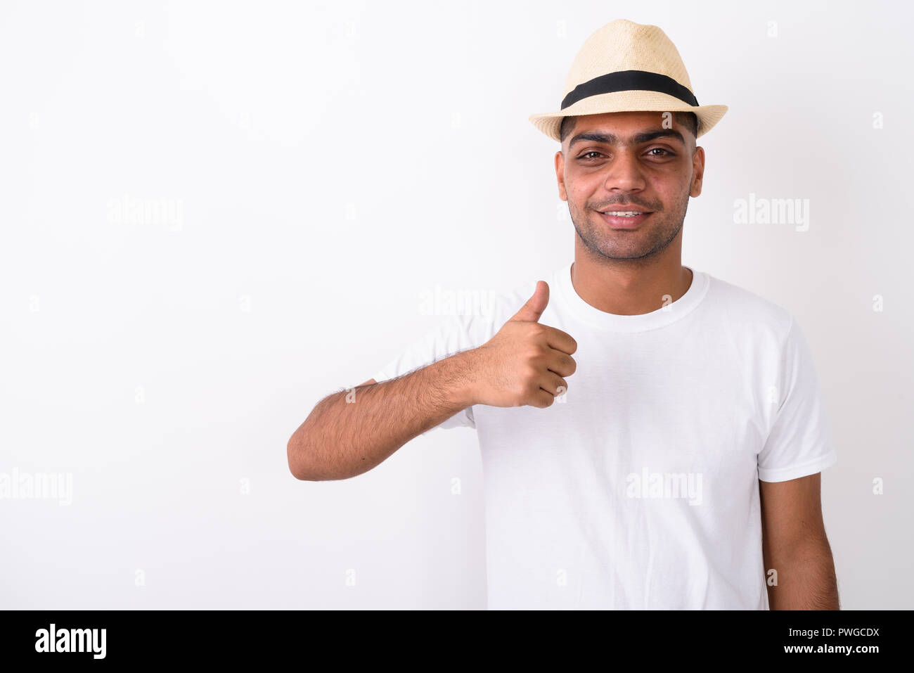 Young Indian tourist man wearing hat against white background Stock Photo