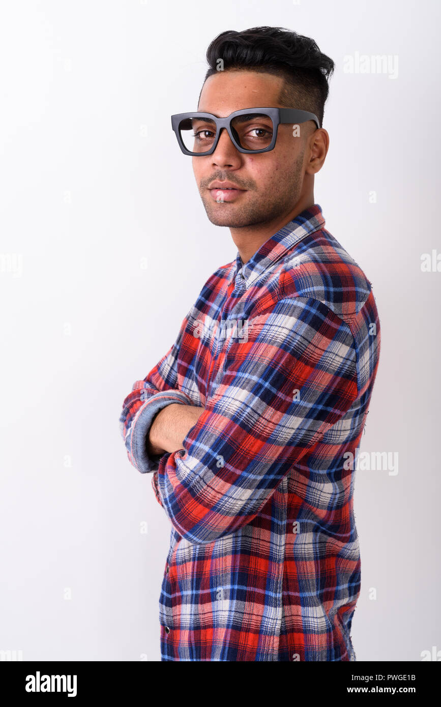 Young Indian man wearing checkered shirt against white backgroun Stock Photo