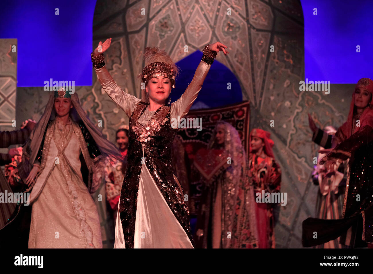 Dancers wearing historical costume during an ethno-cultural performance staged by “El Merosi” ('The People's Heritage') the theater of historical costumes working since 2005 in the city of Samarkand alternatively Samarqand of the Timurid dynasty in Uzbekistan Stock Photo