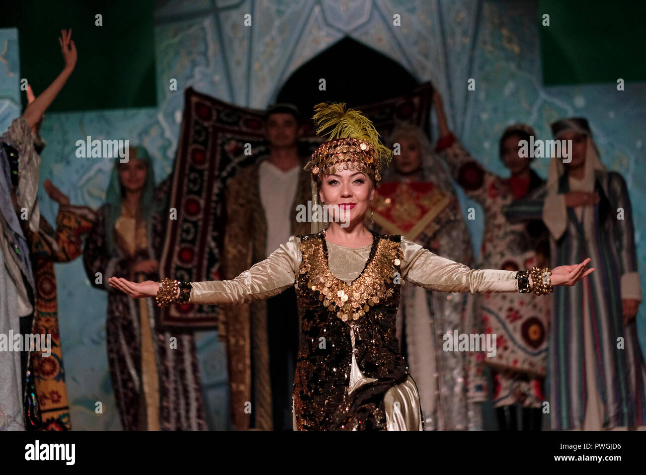 Dancers wearing historical costume during an ethno-cultural performance staged by “El Merosi” ('The People's Heritage') the theater of historical costumes working since 2005 in the city of Samarkand alternatively Samarqand of the Timurid dynasty in Uzbekistan Stock Photo