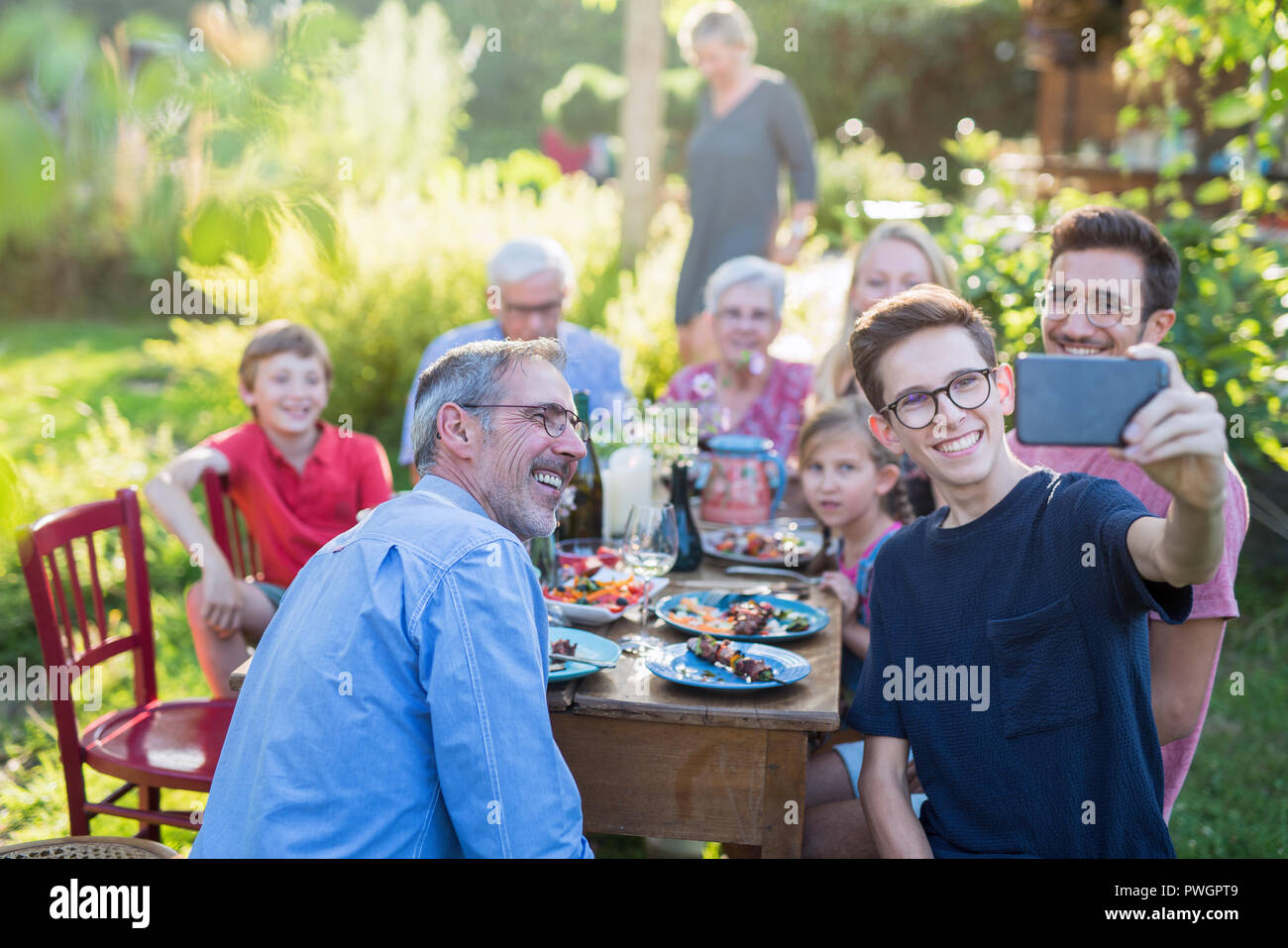 during a bbq a boy does a selfie with the whole family Stock Photo