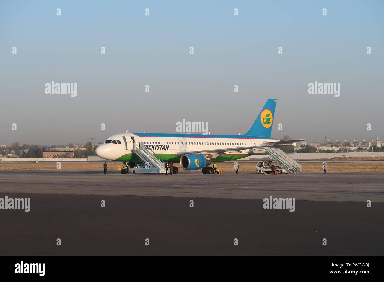 An airplane of National Air Company Uzbekistan Airways stands on the tarmac in Tashkent Airport Uzbekistan Stock Photo