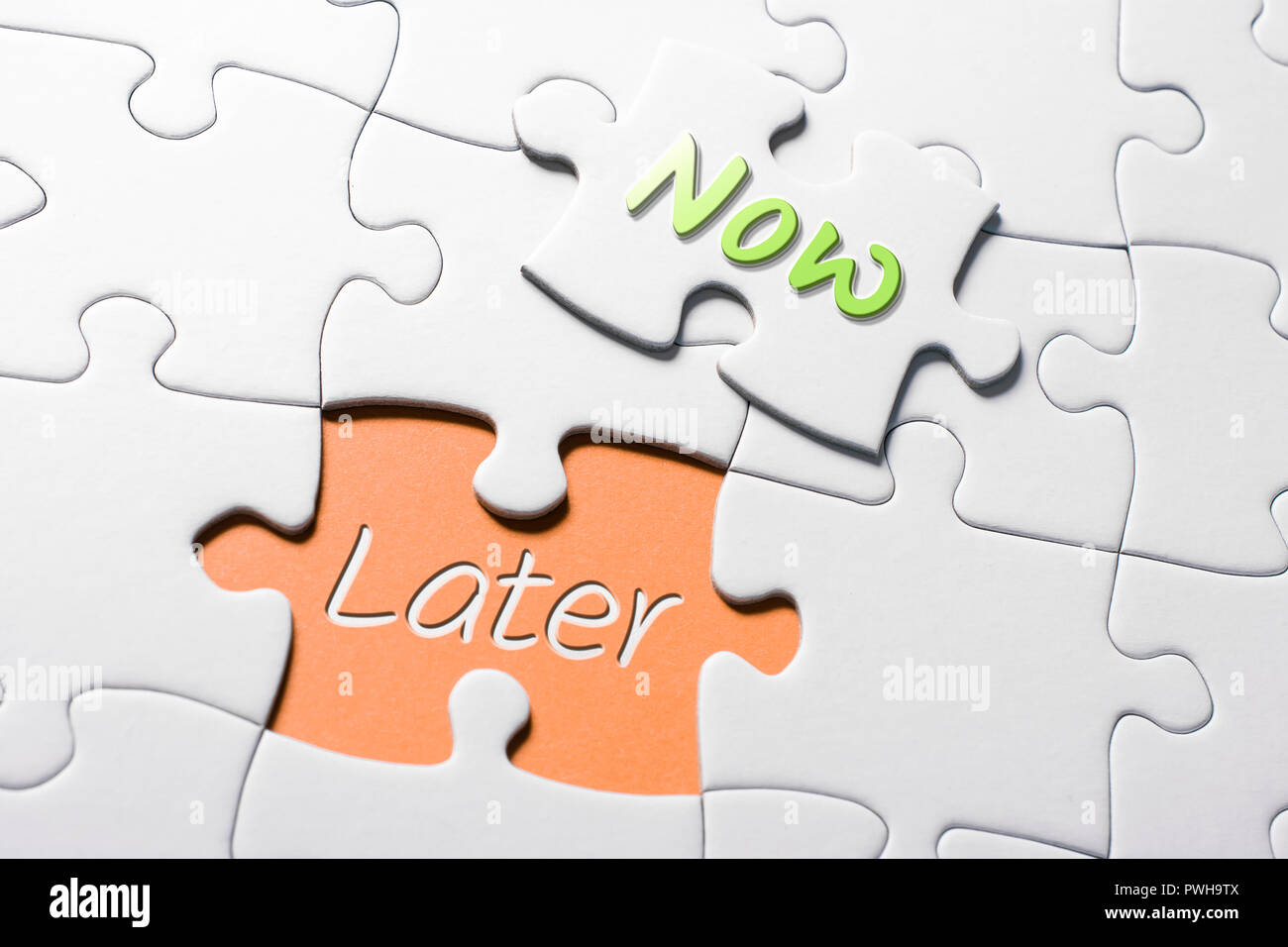 The Words Now And Later In Missing Piece Jigsaw Puzzle Stock Photo