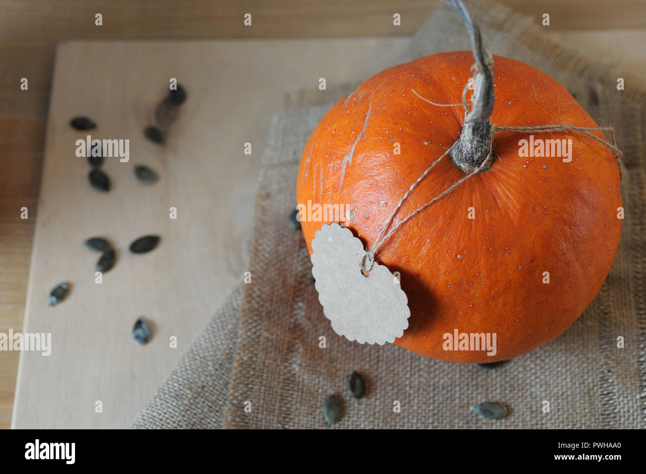 pumpkin and seeds laying on the table,it's time to eat a pumpkin,autumn,cardboard heart Stock Photo