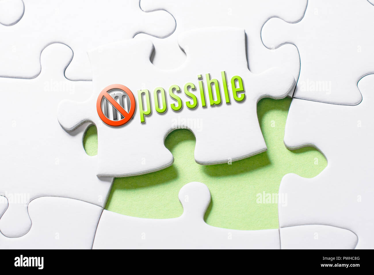 The Word Impossible With Crossed Out IM In Missing Piece Jigsaw Puzzle Stock Photo