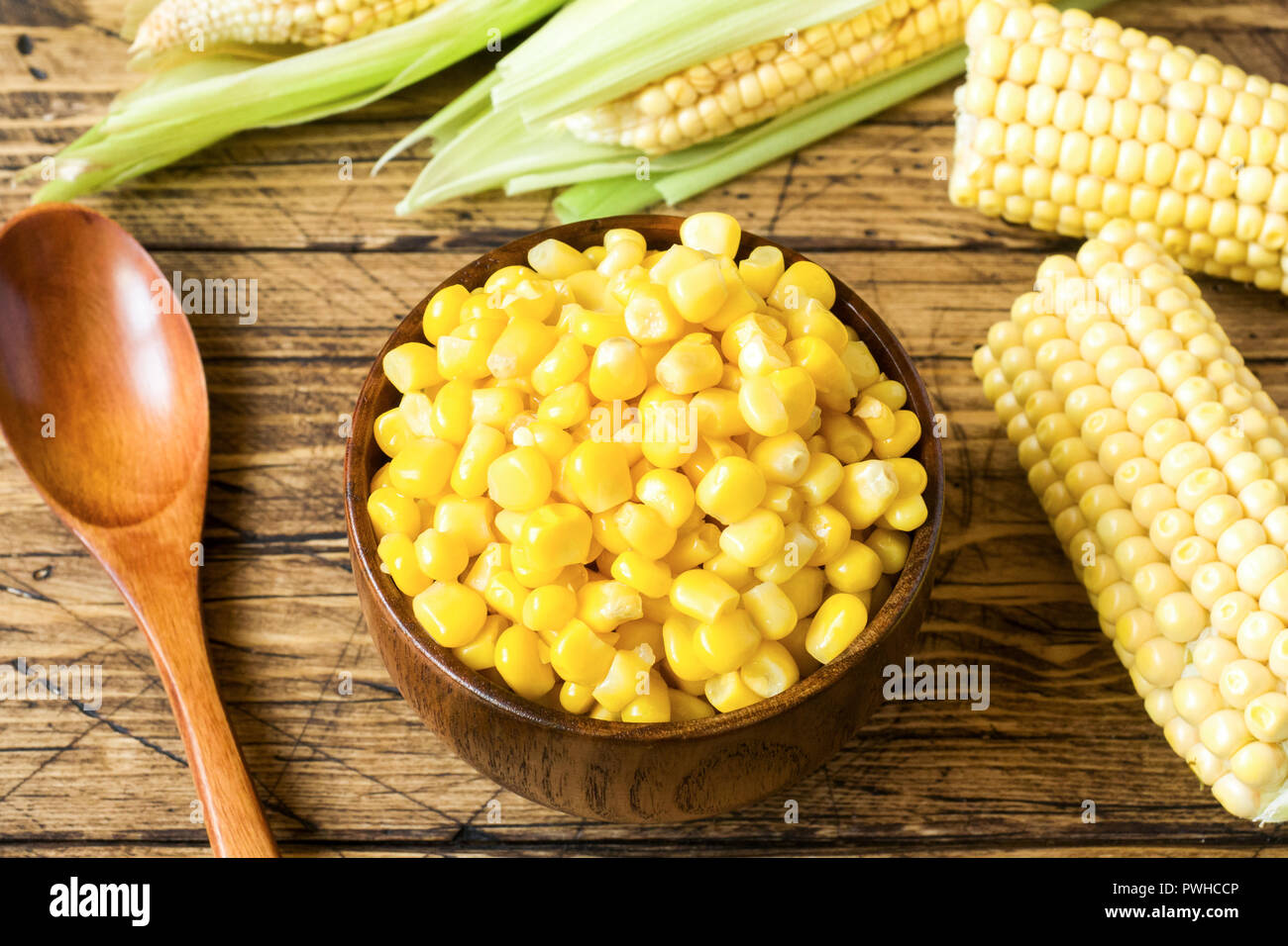 Canned Corn In A Wooden Plate And Cob Of Fresh Corn On A Rustic Wooden Background Stock Photo Alamy