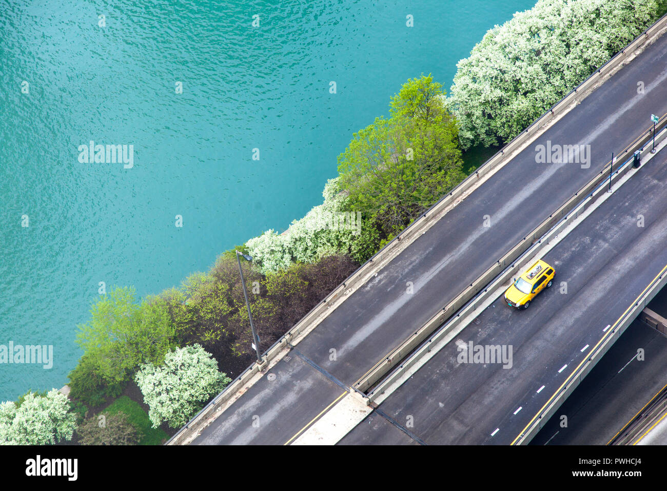 Road, yellow taxi and the Chicago River. Stock Photo