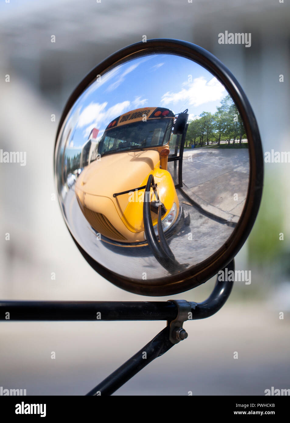 Traditional American school bus relected on its convex mirror Stock