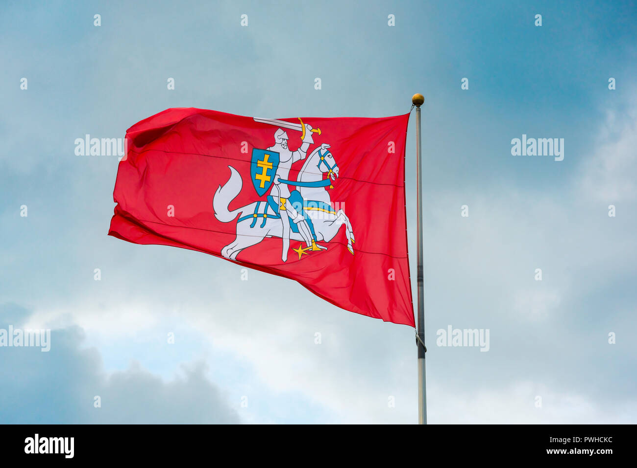 Lithuania flag, view of the Lithuanian state flag showing a white knight riding a white horse on a red background, Vilnius. Stock Photo