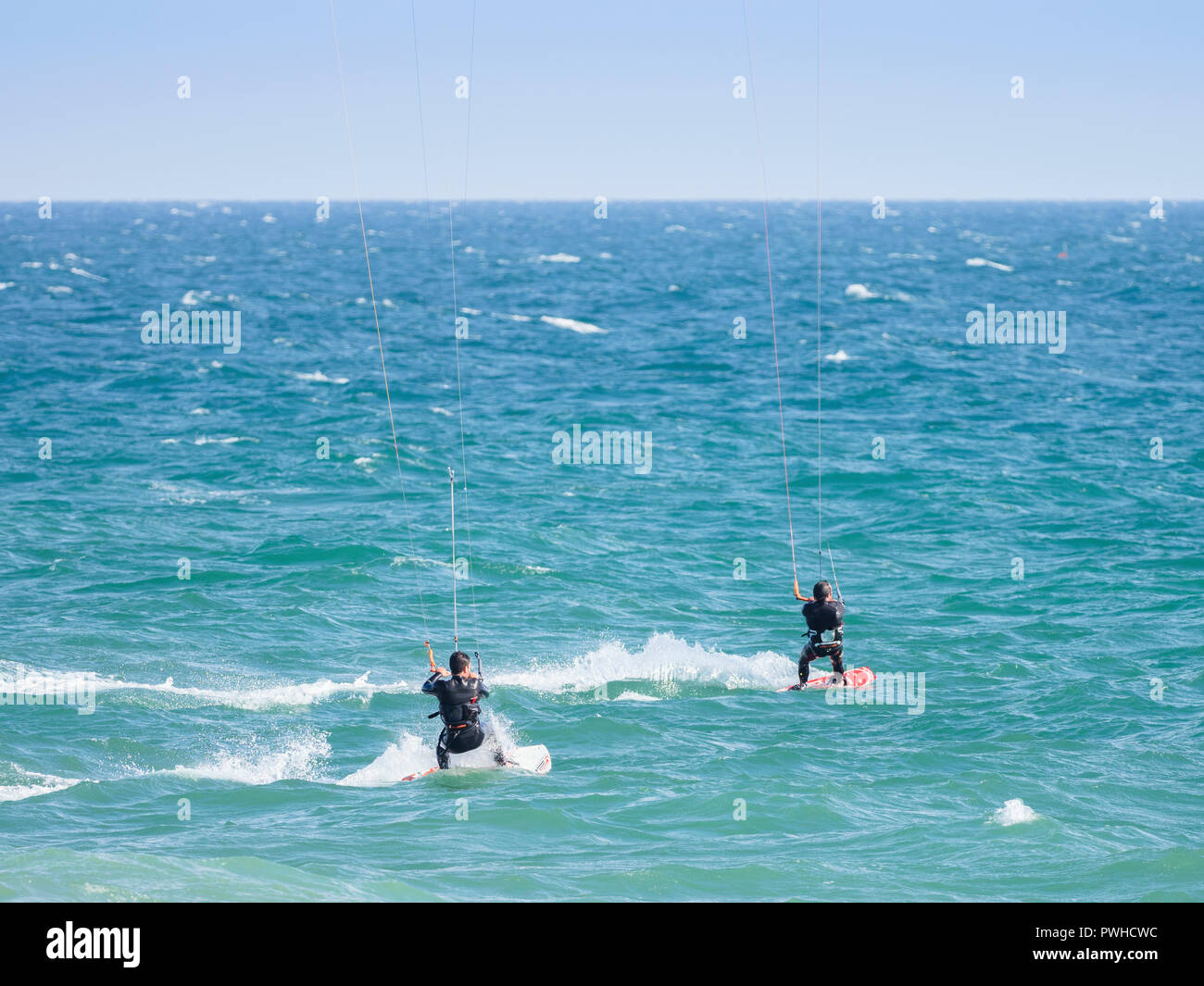 Kite surfers on blue waters of Atlantic Ocean in Algarve, Portugal Stock Photo