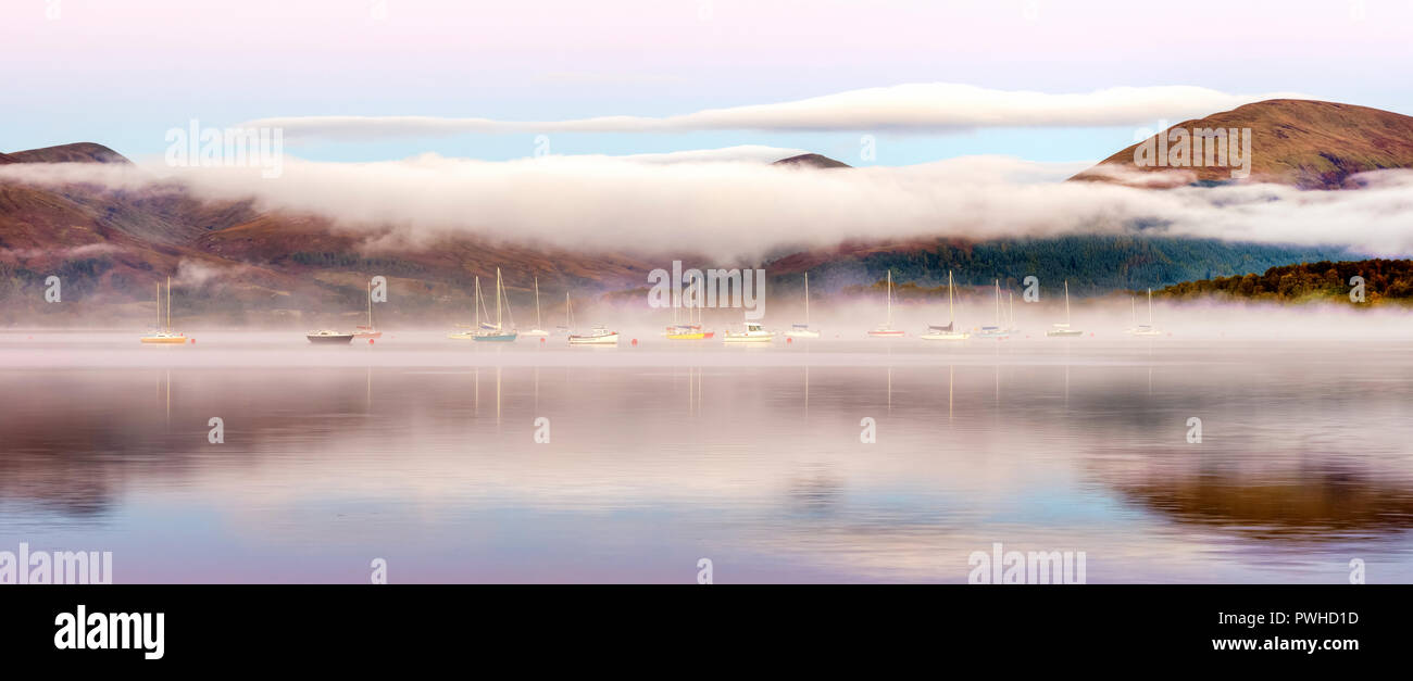 A misty dawn over Loch Lomond from Milarrochy Bay Stock Photo