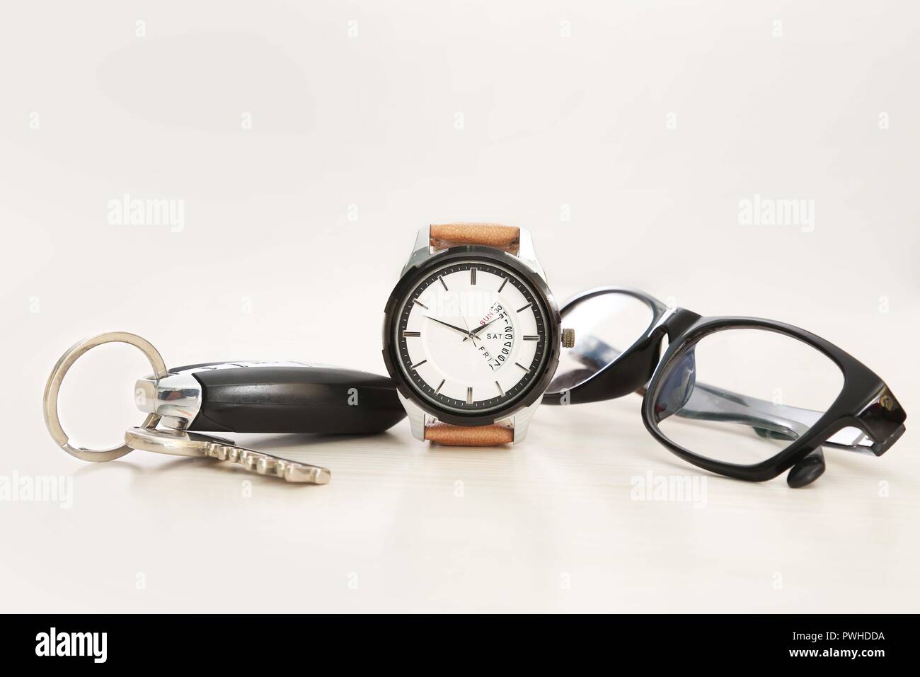 Picture of watch, car key and glasses. Isolated on white background. Stock Photo