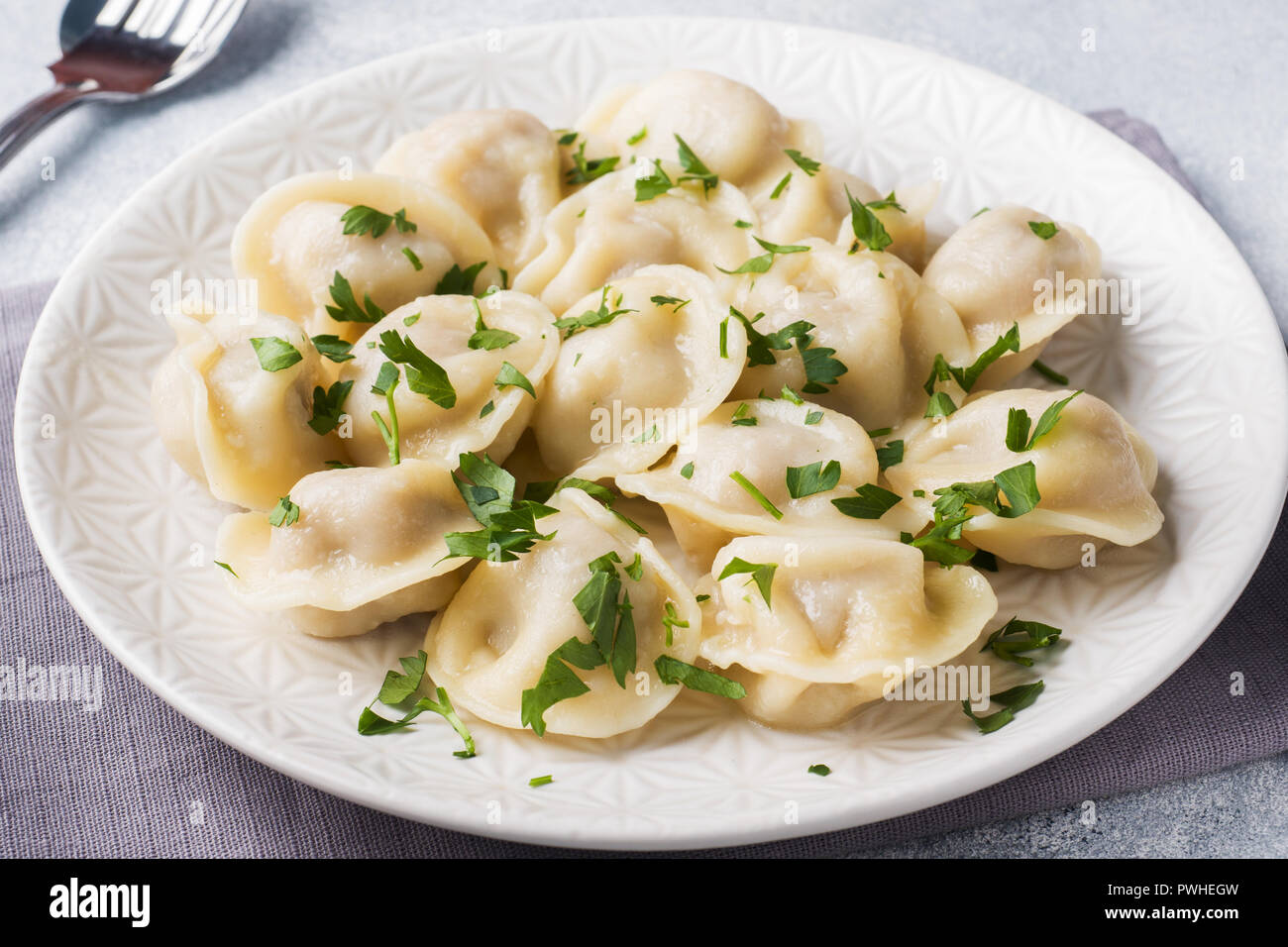 Traditional pelmeni, ravioli, dumplings filled with meat on plate ...