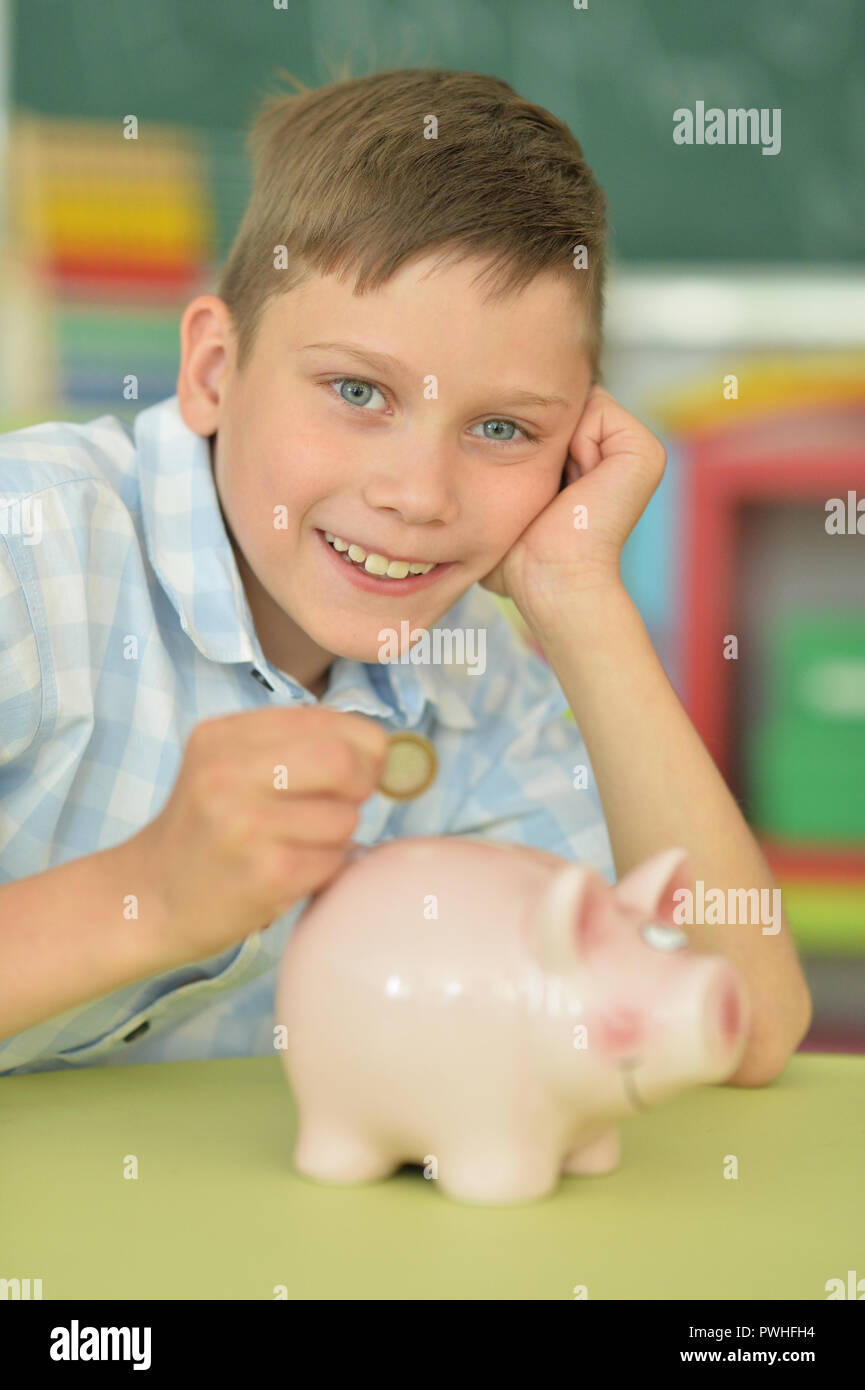 Putting a coin into a piggy bank hi-res stock photography and images ...