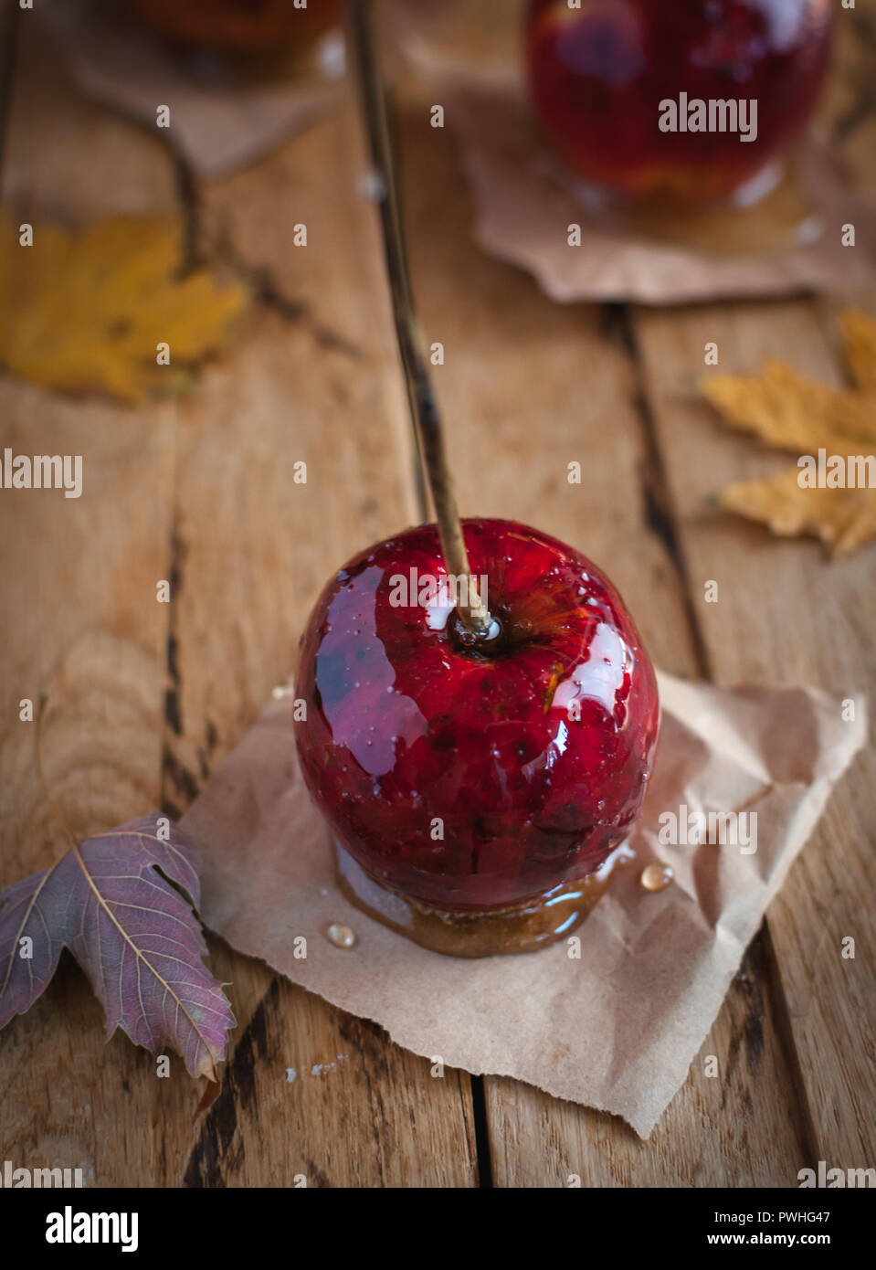 Close-up of candy apple on wooden background Stock Photo