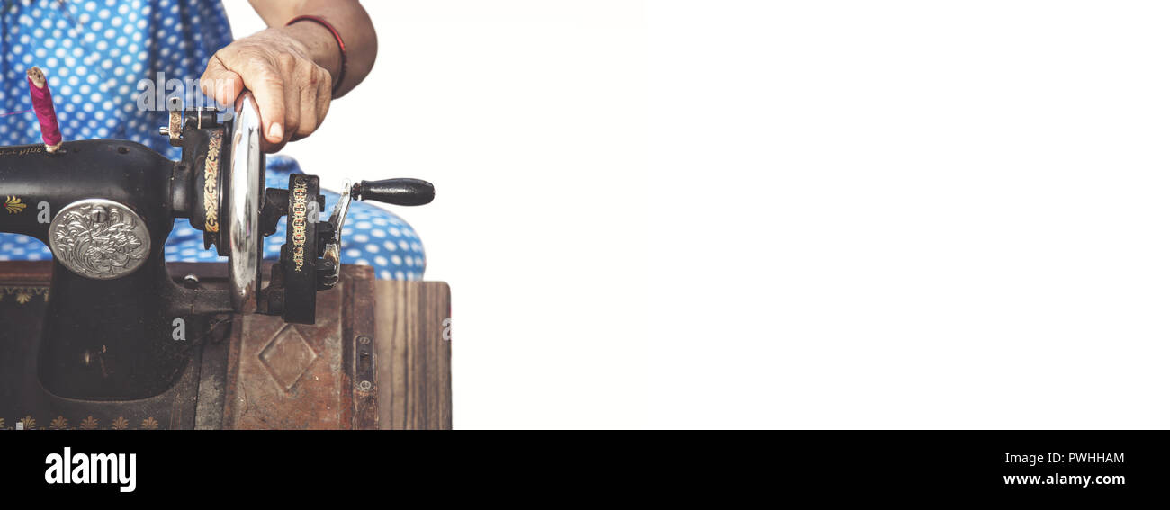 Cropped close up of a woman using sewing machine Stock Photo