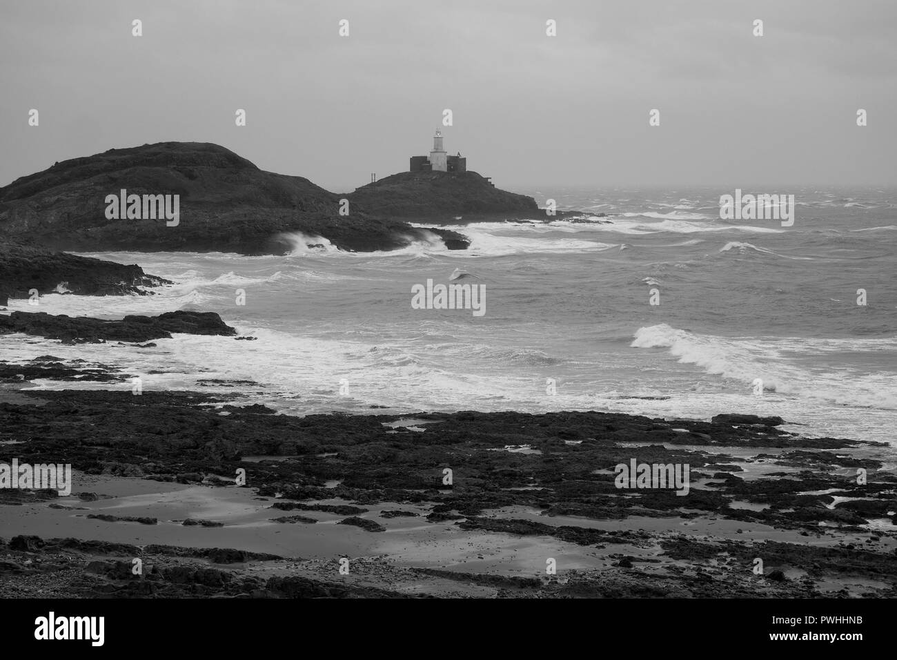 Mumbles Lighthouse lit up on a stormy day overlooking Bracelet Bay, the Gower Peninsula near Swansea, South Wales Stock Photo