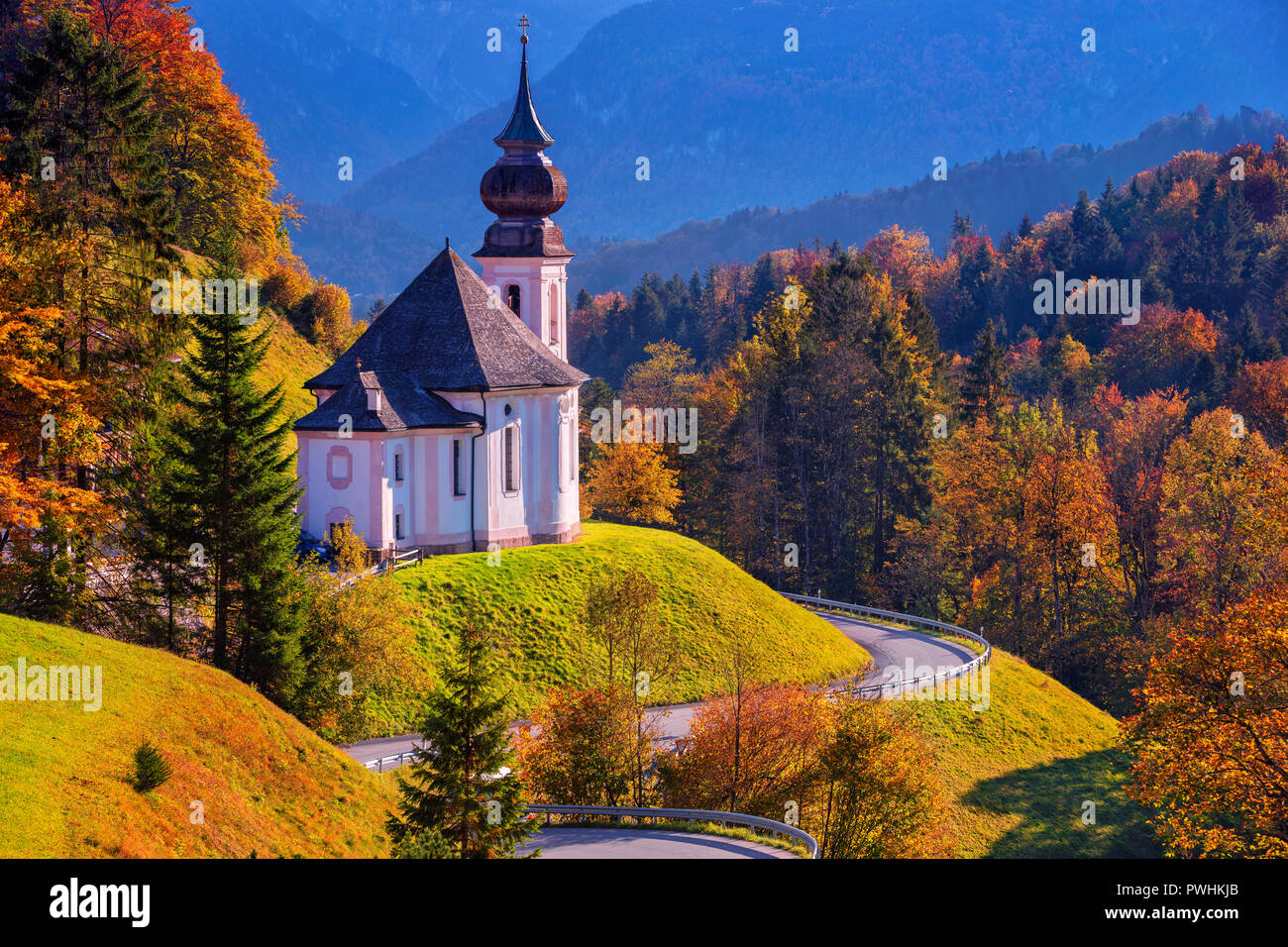 Autumn in Alps. Image of the Bavarian Alps with Maria Gern Church and Watzmann mountain during beautiful autumn day. Stock Photo