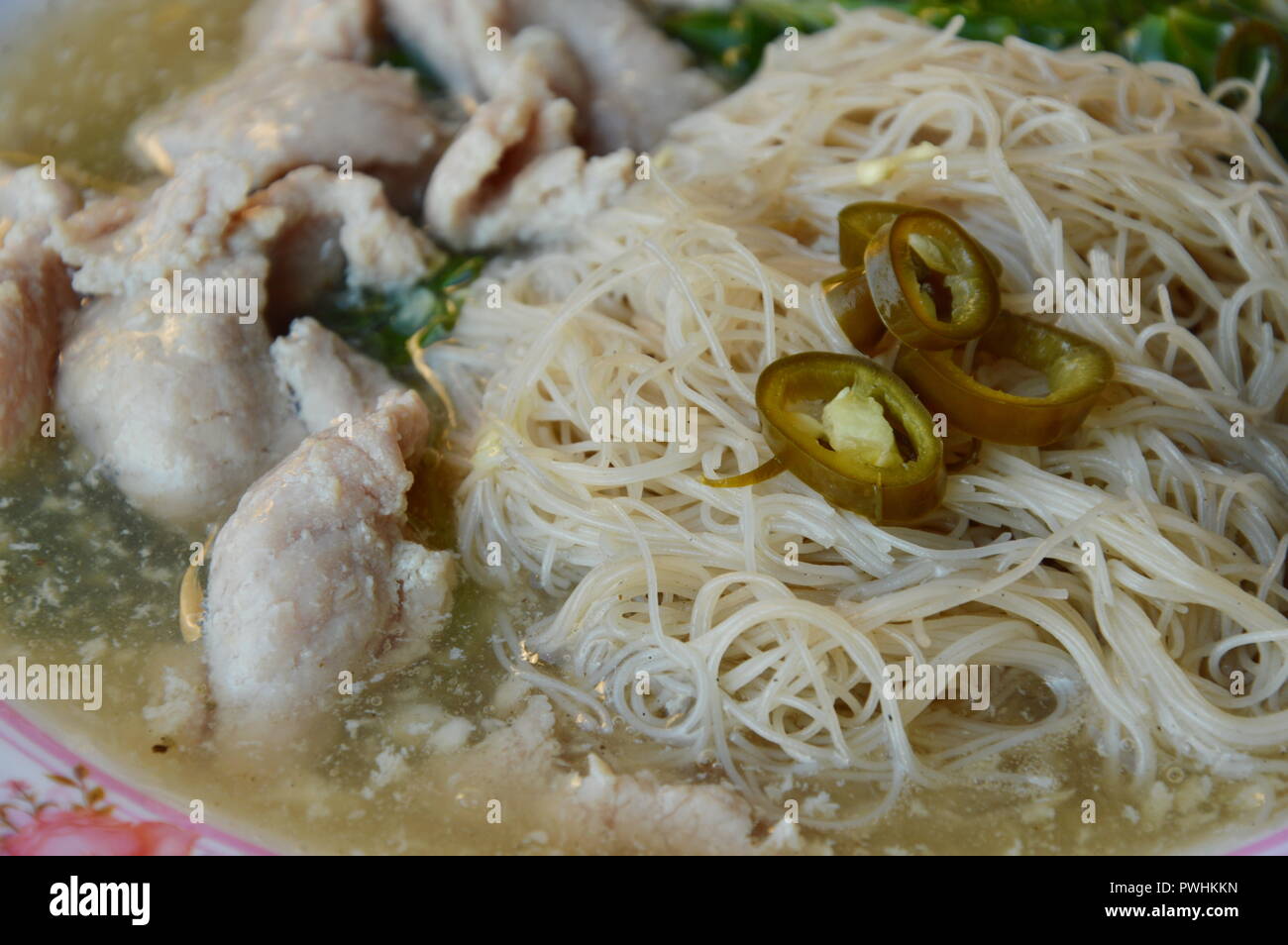 thin rice noodle with gravy sauce topping slice pickled chili Stock