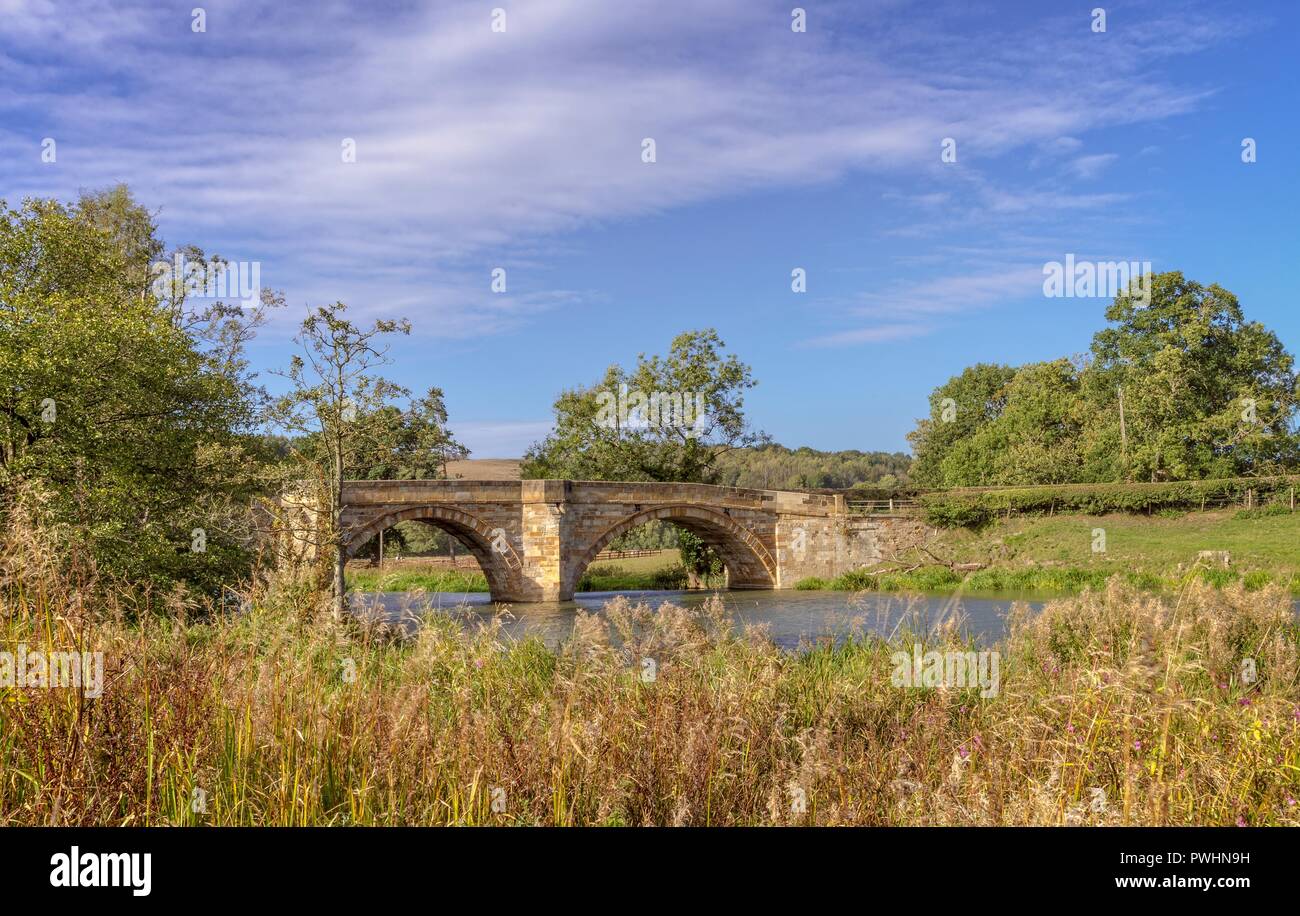 The Arches Of A 19th Century Bridge Spans The River Derwent. Grass ...