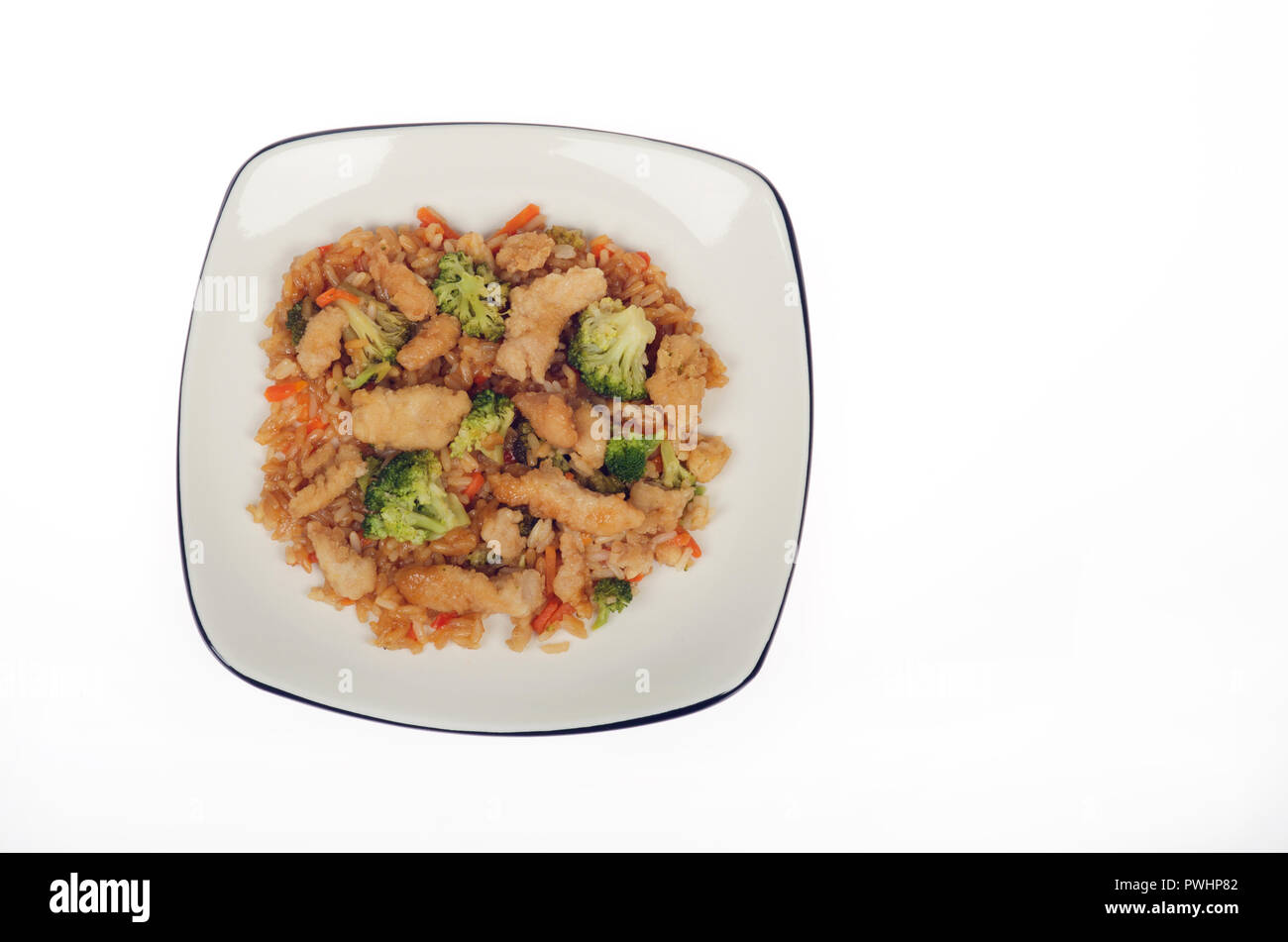 Plate of asian chicken pad thai with vegetables, including broccoli and rice Stock Photo