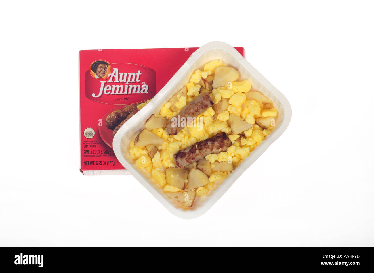 Hot, microwaved from frozen breakfast tray from Aunt Jemima of scrambled eggs, roasted potatoes and sausage links on white with box Stock Photo