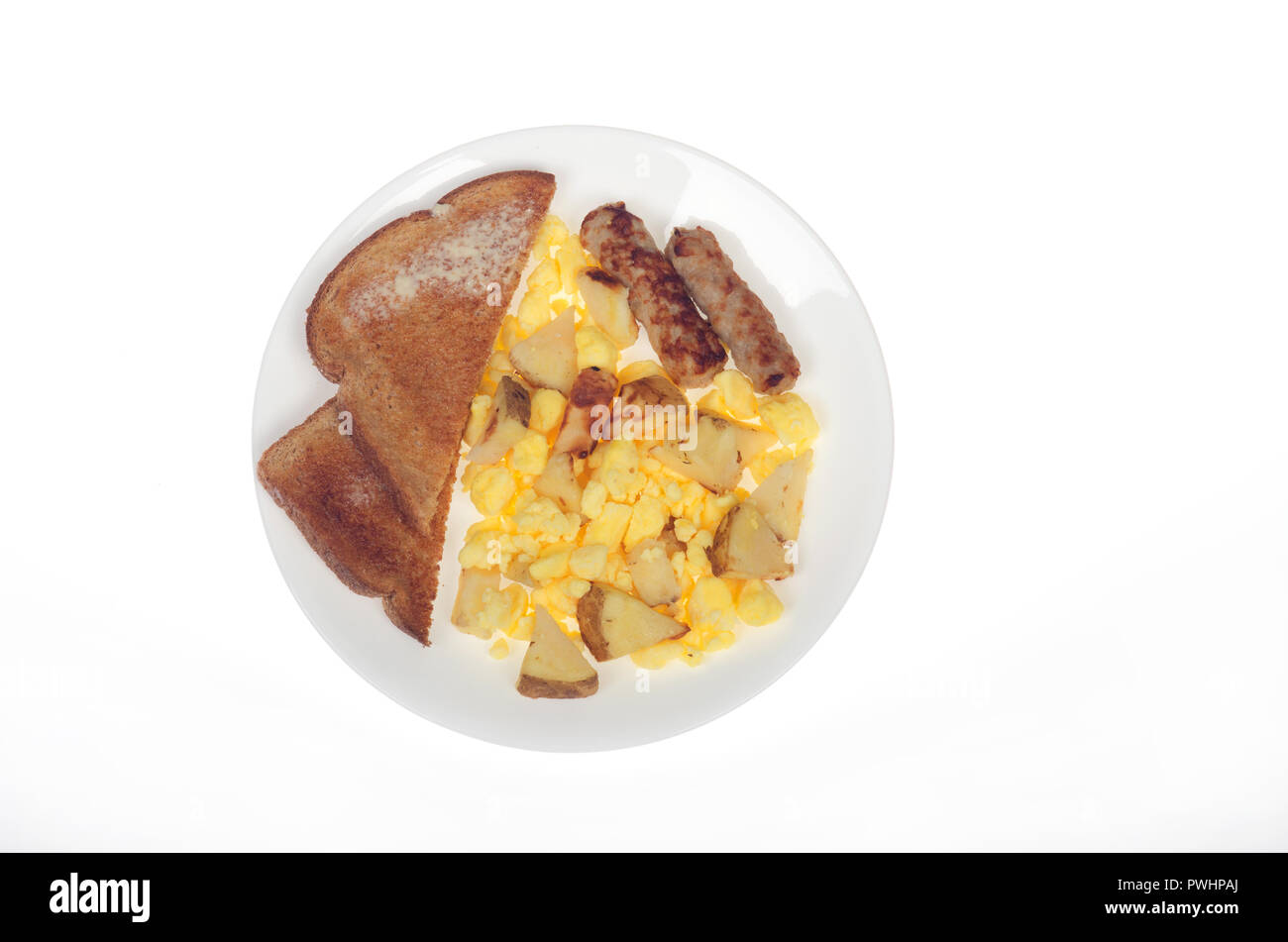 Scrambled eggs, roasted potatoes, sausage links and whole wheat bread Stock Photo