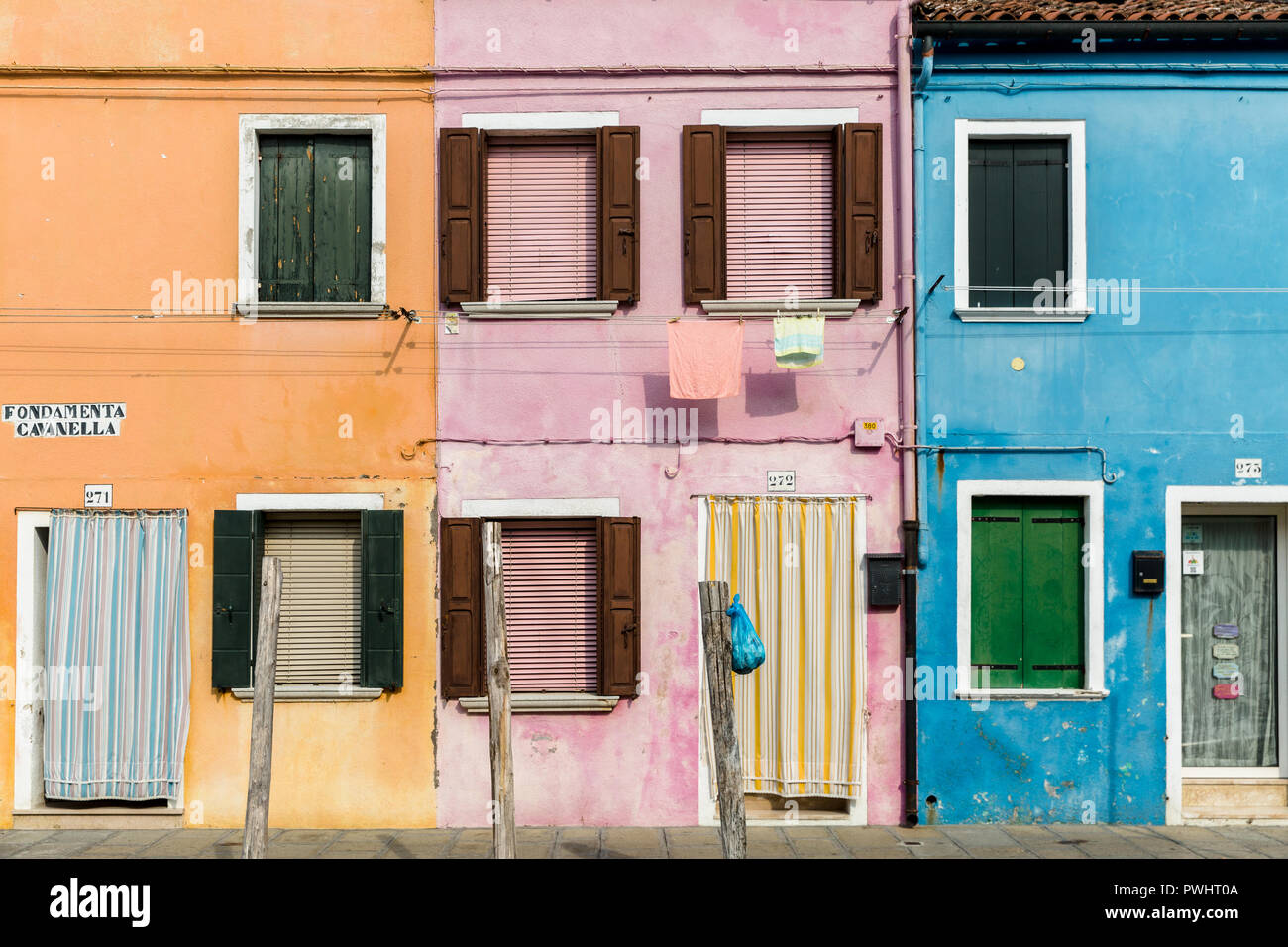 Colourful terraced houses with washing lines in Burano, Venice, Italy Stock Photo