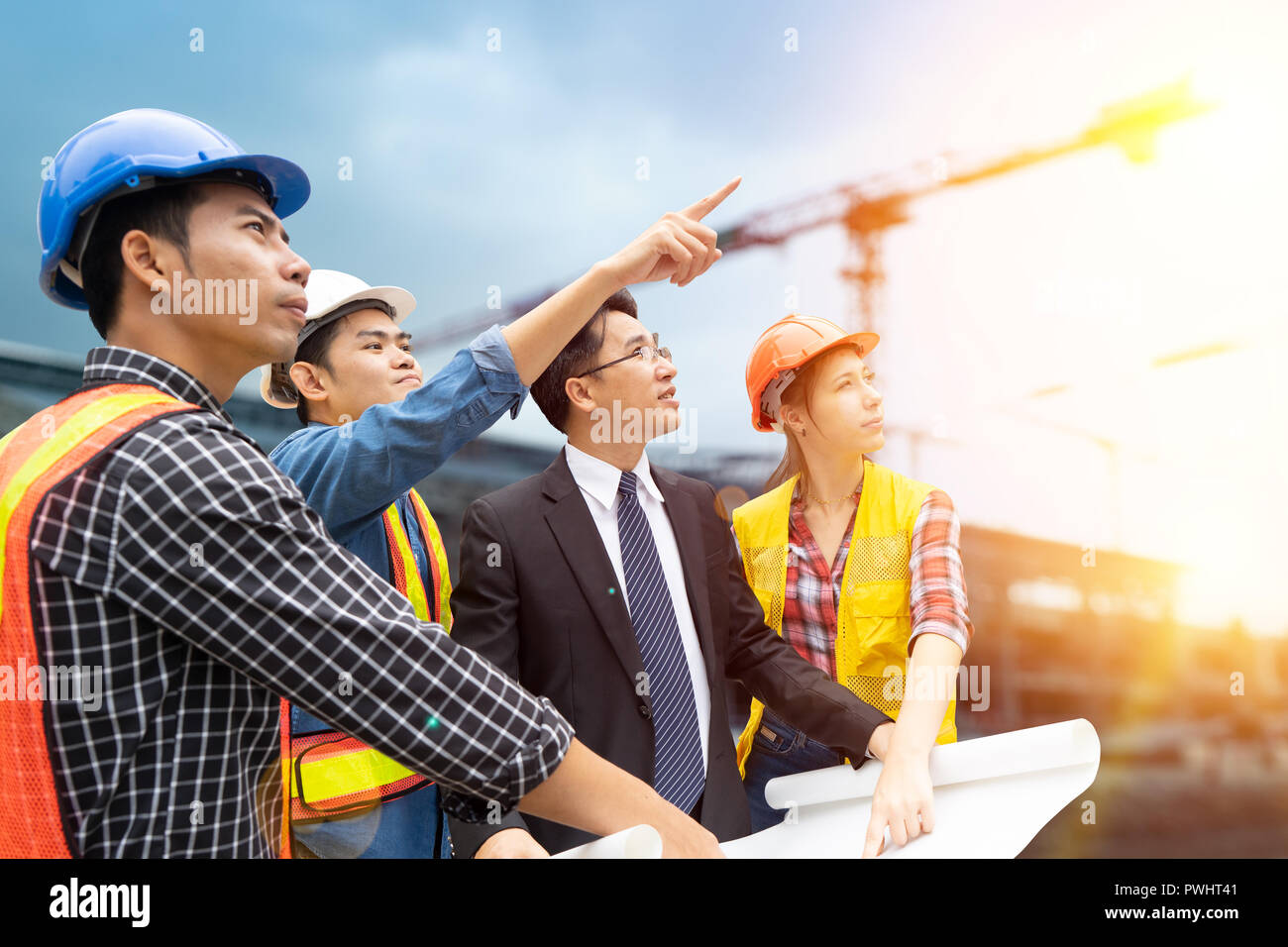 Group of engineer people working on construction site background Stock ...