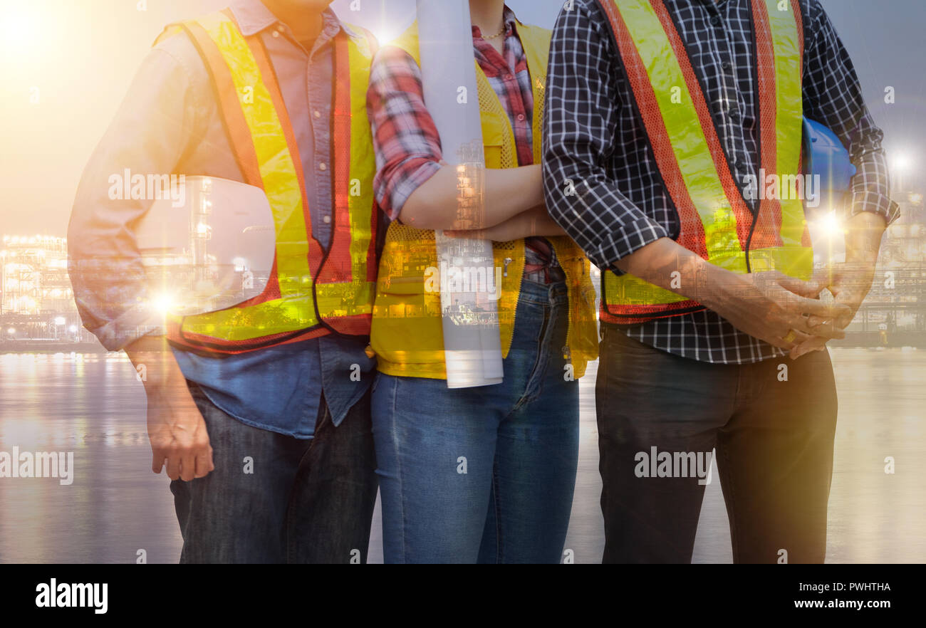 Double exposure of Group of engineer people working on Industrial site background Stock Photo