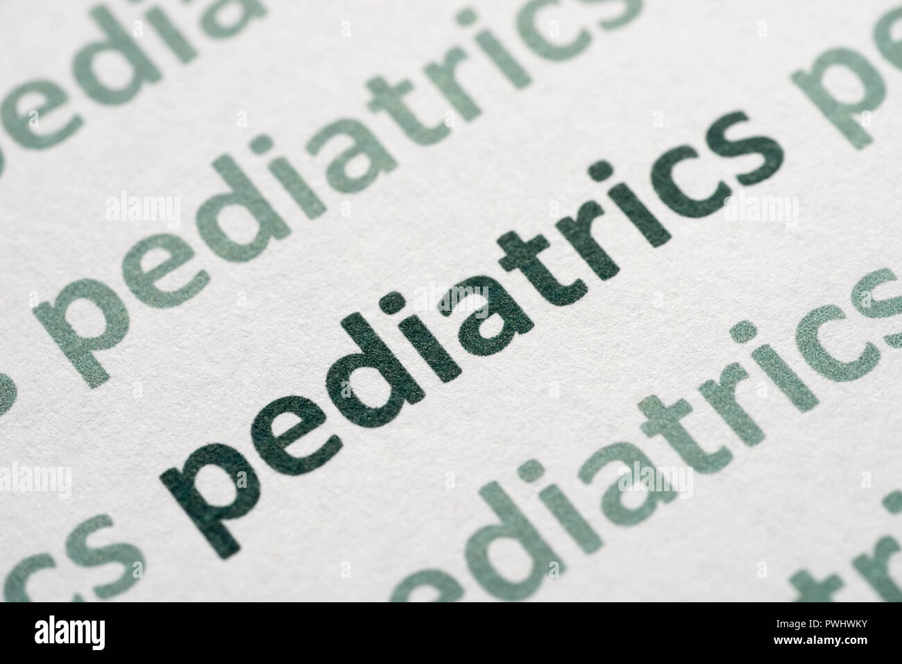 word  pediatrics printed on whte paper macro Stock Photo