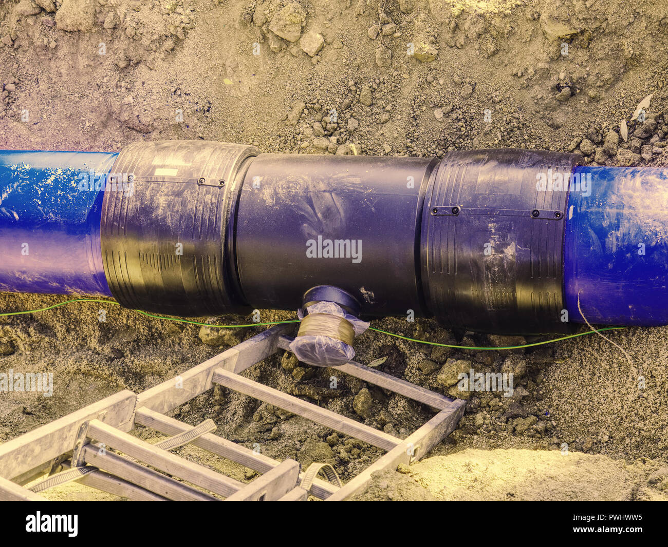 Trench for laying a water supply pipeline. Construction of drinking water pipes with gate in