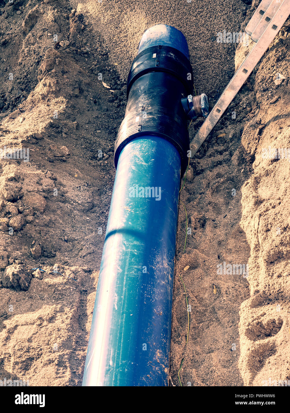 Trench for laying a water supply pipeline. Construction of drinking