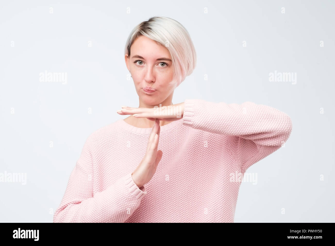 Beautiful Young Woman With Dyed Short Hair Showing Time Out