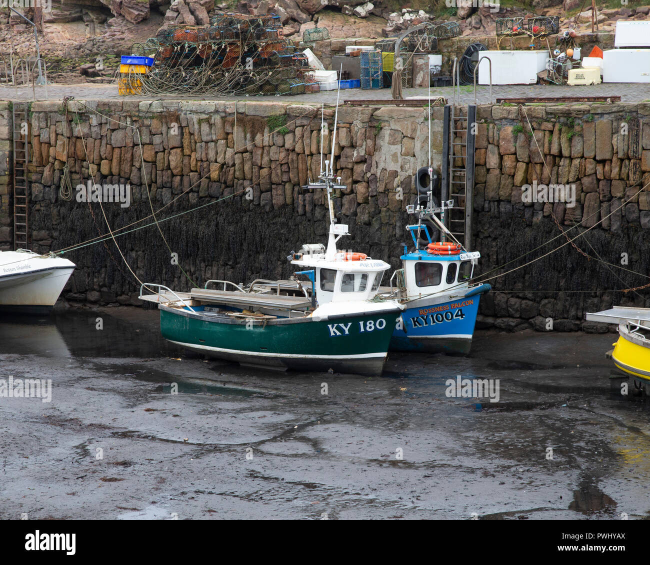 Inshore fishing boats in Crail Harbour at low tide Stock Photo - Alamy