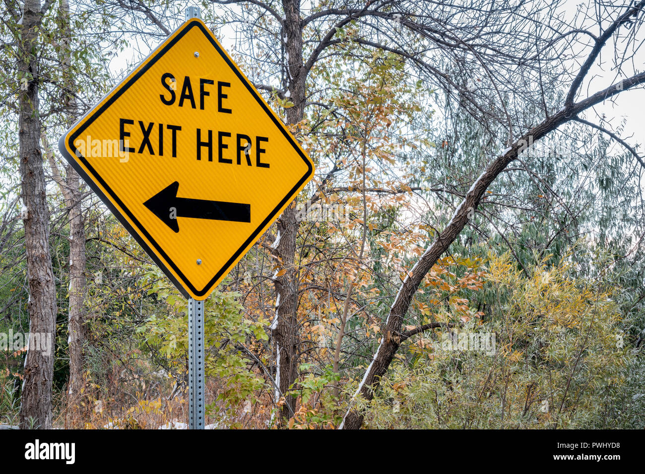 safe exit here sign on a river shore direction to boat landing above