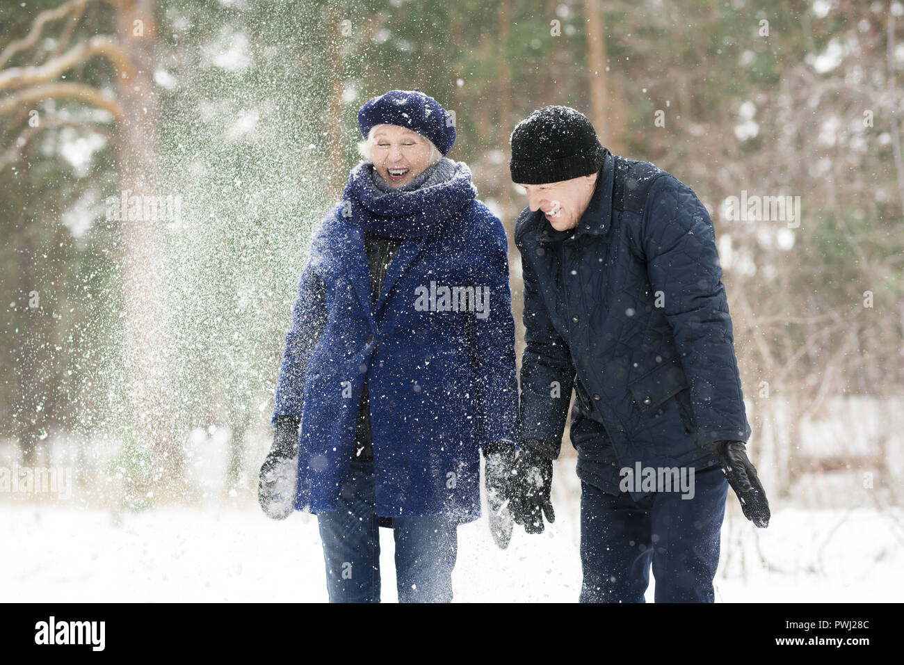 Senior Couple Playing with Snow Stock Photo