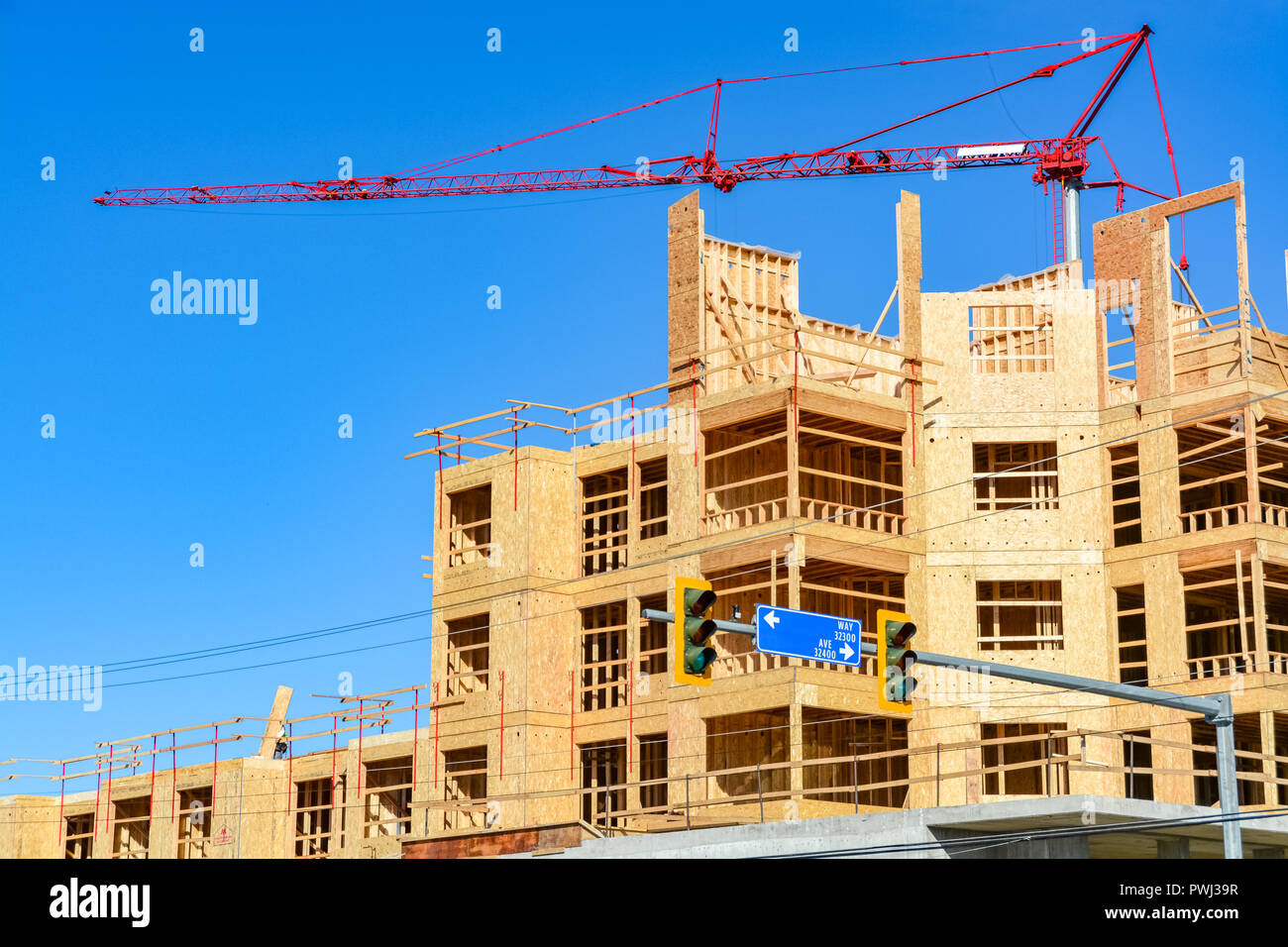 Six storey frame building under construction on concrete foundation bed