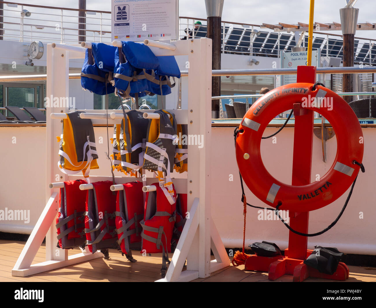 Life Ring And Life Jackets On A Cruise Ship Pool Deck Stock Photo