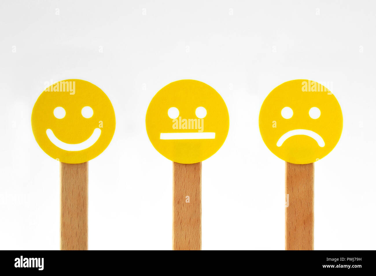 Yellow smiley faces with positive, neutral and negative expression Stock Photo