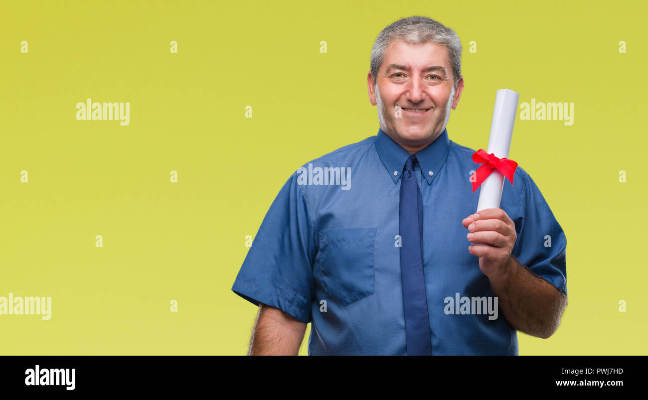 Handsome senior man holding degree over isolated background with a ...